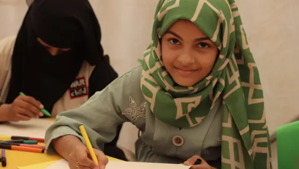 Yemeni girl in temporary learning space.