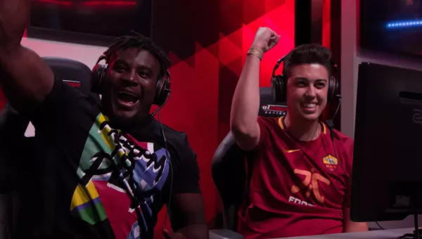 Gamers cheer as they play football gaming tournament for War Child.