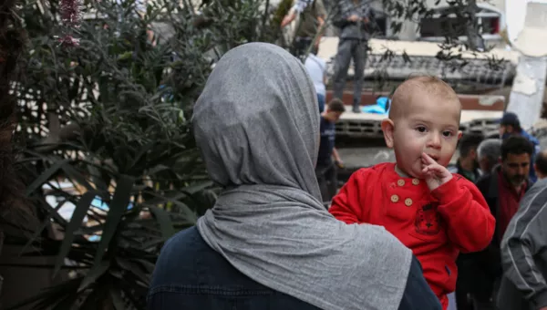A mother and her child walking in Gaza.
