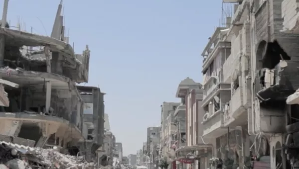 Child running in Gaza in between collapsed buildings. 