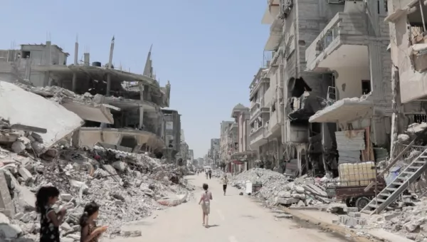 Child running through collapsed buildings in Gaza. 