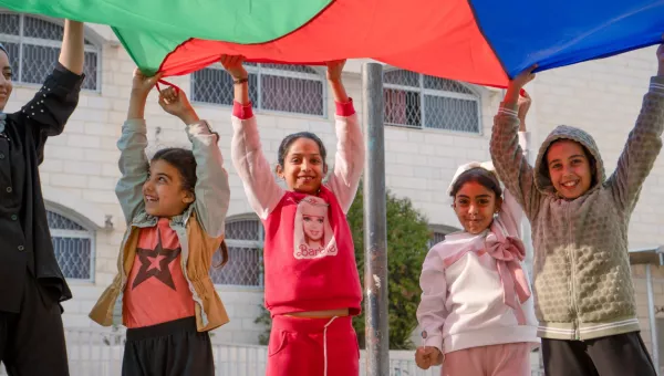 Children playing with a parachute.