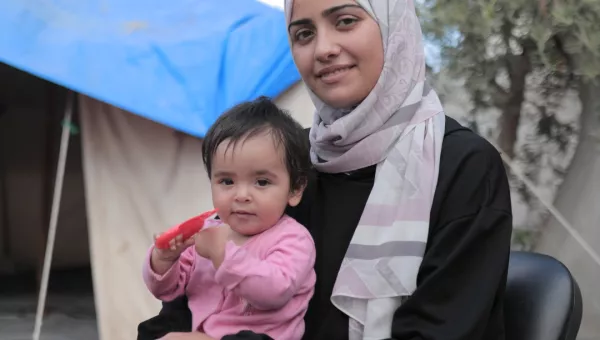 A woman with a child sitting on her lap.