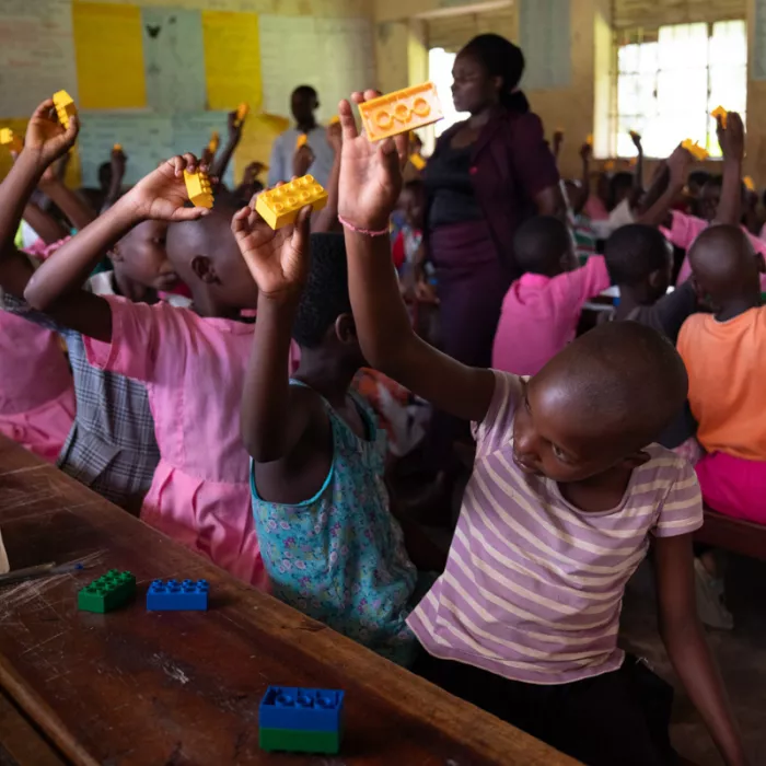 A teacher and her pupils in a classroom in Uganda. 